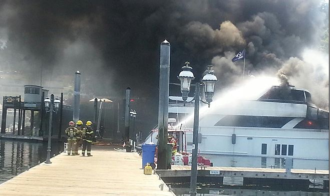 Firefighters fighting boat fire